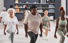 Women exercising with dumbbells in gym