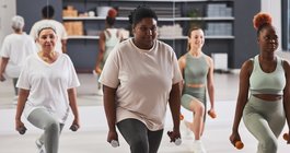 Women exercising with dumbbells in gym