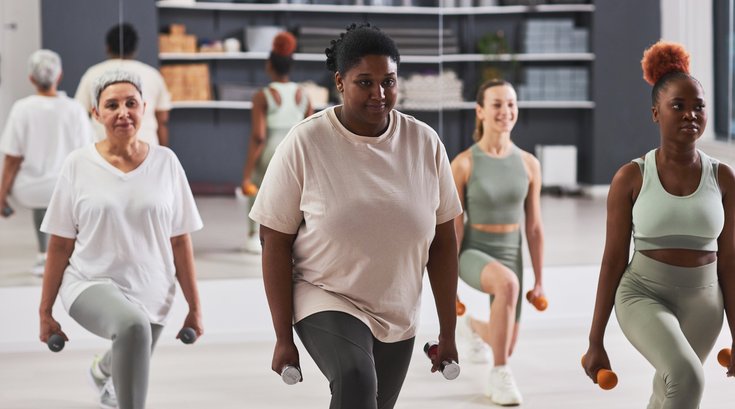 Women exercising with dumbbells in gym