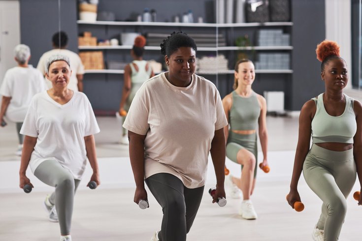 Women exercising with dumbbells in gym