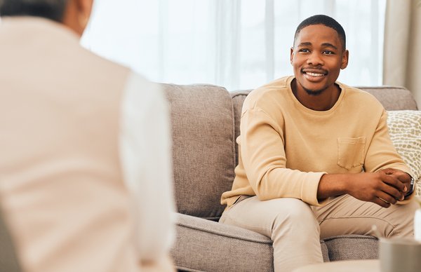 Purchased - Man talking with a therapist smiling