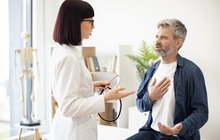 Purchased - man speaking with doctor about heart health