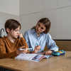 Purchased - boy feeling frustrated while doing homework with mom at home