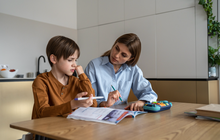 Purchased - boy feeling frustrated while doing homework with mom at home