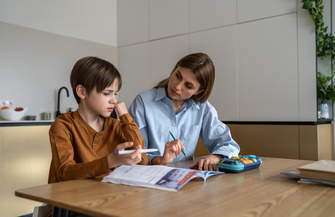 Purchased - boy feeling frustrated while doing homework with mom at home