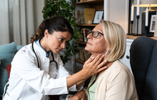 Limited - Doctor checking a woman's thyroid