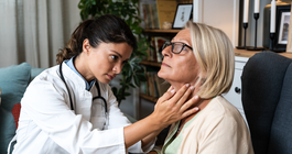 Limited - Doctor checking a woman's thyroid