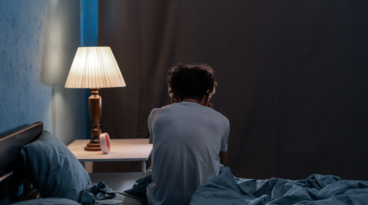 Puchased - Sleepless, man suffering from insomnia, sleep apnea or stress.