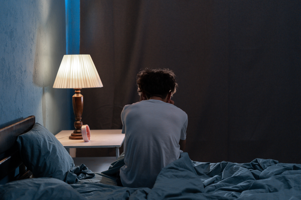 Puchased - Sleepless, man suffering from insomnia, sleep apnea or stress.