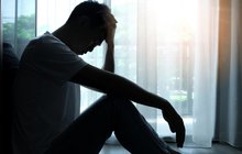 Purchased - A depressed person sitting on the floor