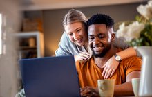 Purchased - Couple reviewing health plans on laptop