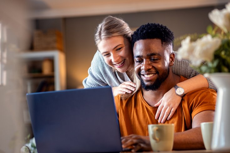 Purchased - Couple reviewing health plans on laptop