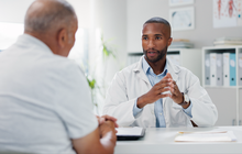Purchased - Doctor having a serious conversation with a patient