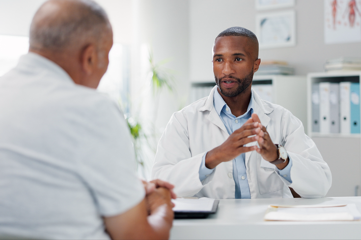 Purchased - Doctor having a serious conversation with a patient