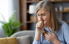 Purchased -  woman coughing, feeling unwell in living room