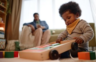 Purchased - Girl Playing with Building Blocks while Sitting on Carpet in Living Room