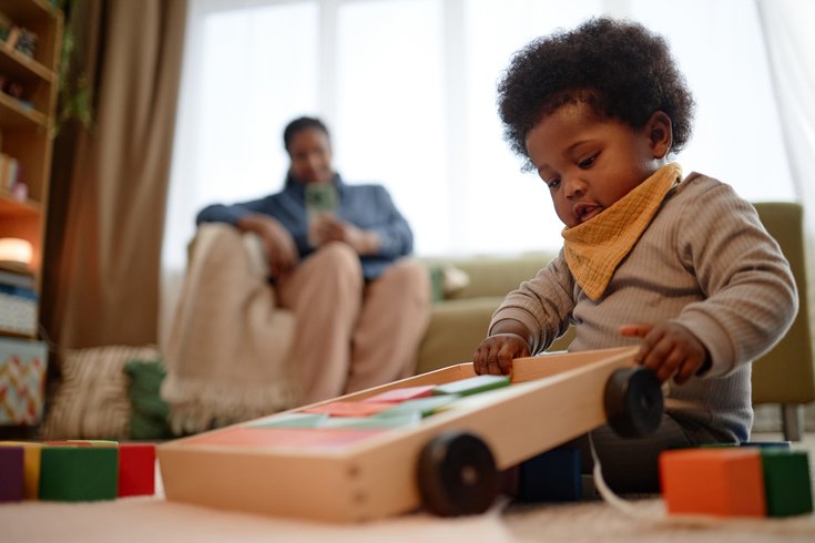Purchased - Girl Playing with Building Blocks while Sitting on Carpet in Living Room