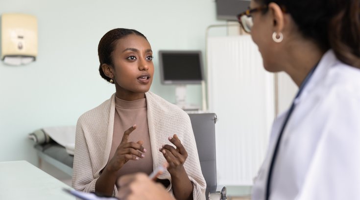 Purchased - a woman speaking with her doctor