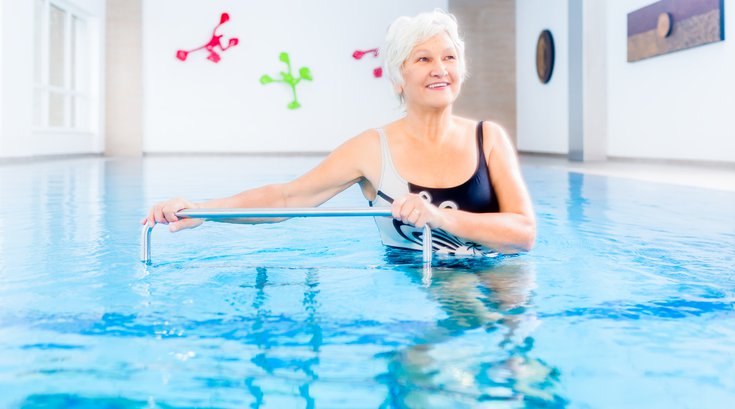 Purchased - senior citizen in a pool exercising
