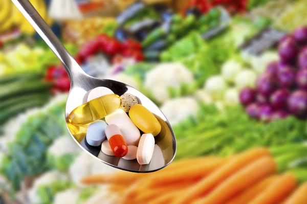 Spoon with pills, dietary supplements