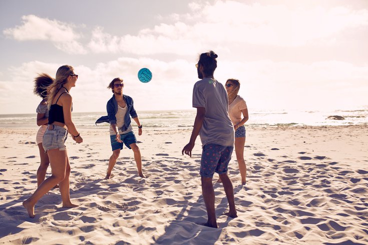 Purchased - Friends playing volleyball on beach