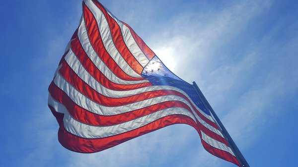Purchased - American flag flying in the wind