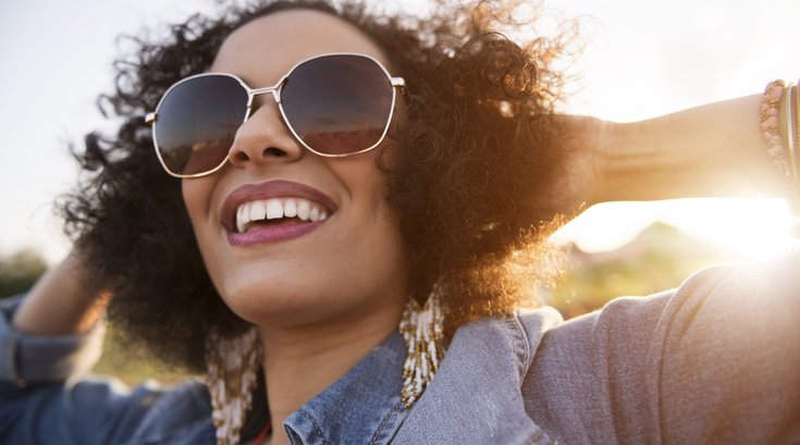 Purchased - Close up of woman wearing sunglasses smiling