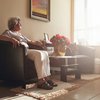 Senior woman sitting alone on a chair at home