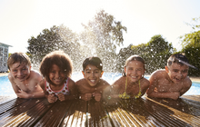 Limited = Kids Swimming in Pool Posing for a photo