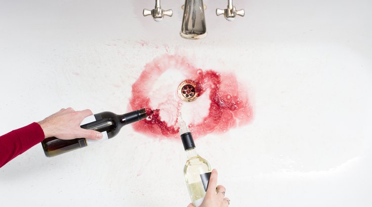 Purchased - Wine being poured down the drain