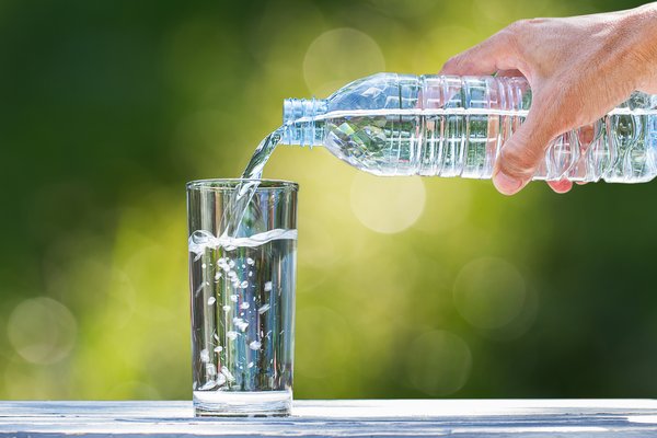 Pouring water into a glass - hydration