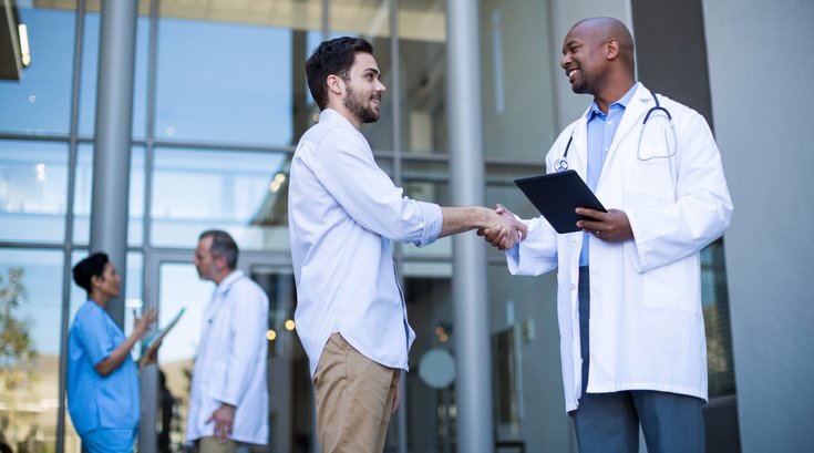 Patient shaking hands with a doctor