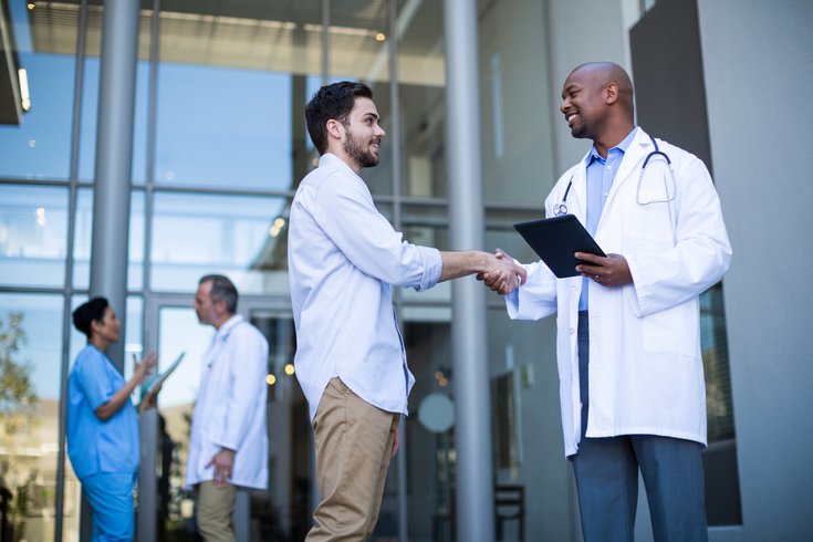 Patient shaking hands with a doctor