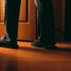 Man walking into a bathroom at night 
