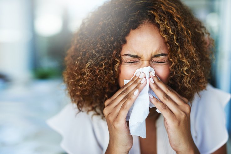 Woman blowing her nose