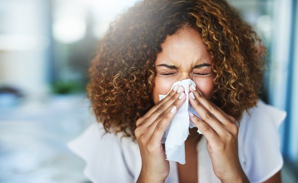 Woman blowing her nose