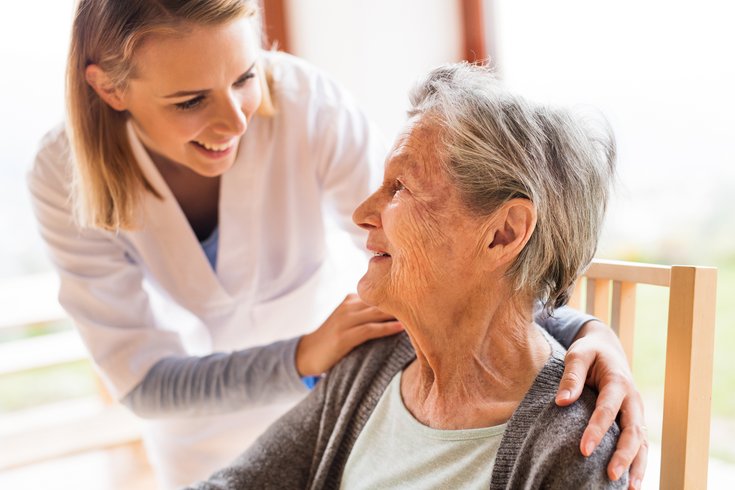 Health visitor and senior woman during home visit