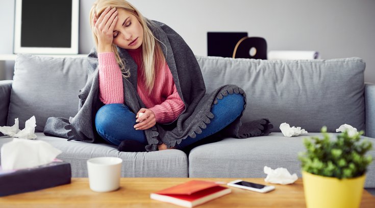 Woman on couch not feeling well