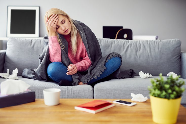 Woman on couch not feeling well