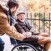 Senior father in wheelchair and young son