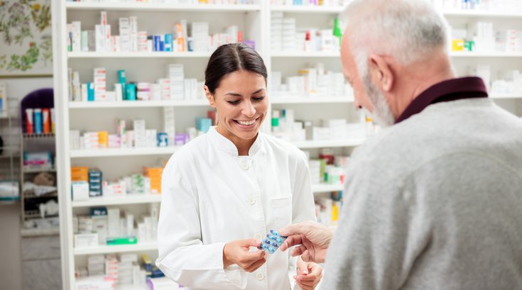 Pharmacist speaking to customer