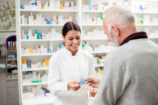 Pharmacist speaking to customer
