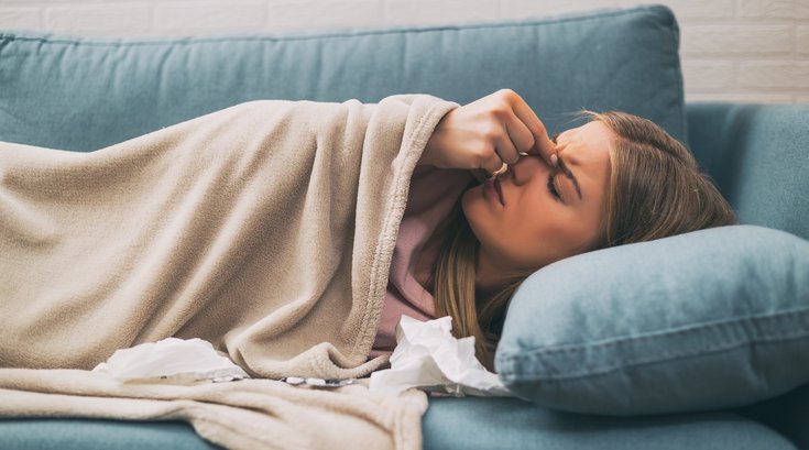 Sick person laying on couch