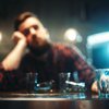 Purchased - Man drinking alone at a bar