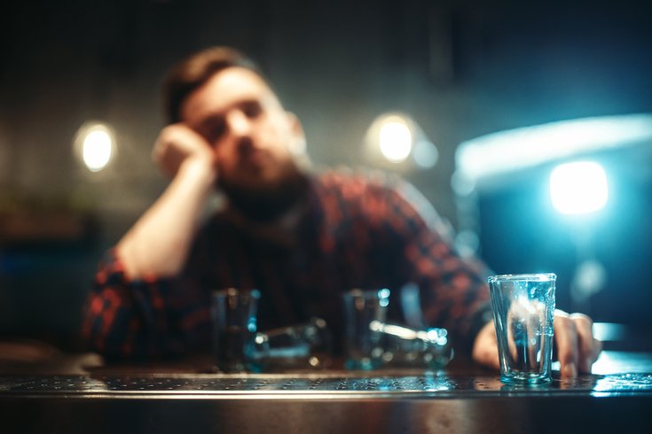 Purchased - Man drinking alone at a bar