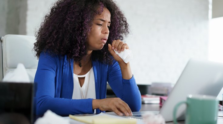 Woman coughing at work