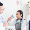 Doctor examining patient with asthma