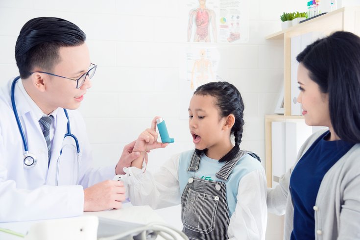 Doctor examining patient with asthma