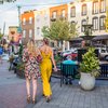 People stroll East Passyunk Avenue during Passyunk Passeggiata