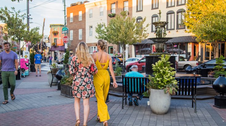 People stroll East Passyunk Avenue during Passyunk Passeggiata